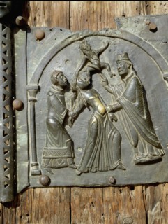 Detail of the bronze door of the Basilica of San Zeno which is decorated with 48 panels illustrating biblical stories and the lives of St Peter, St Paul, St Zeno, St Helena among others, and items con...