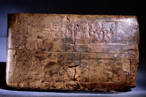 Ur III clay administrative tablet, impressed with the scribes seal, which depicts a goddess leading a worshipper and the text Ur Gigir, scribe, son of Barran