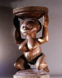 Prestige chiefs stool supported by kneeling woman
