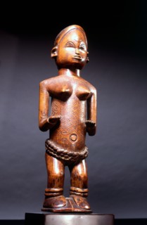 Small wood figure with inset ivory eyes, showing female scarification patterns