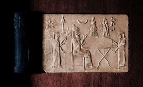 Depiction of seated king holding a drinking bowl and two attendants with fan and fly whisk