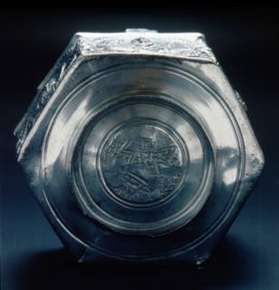 The base of a six sided silver vessel which is marked by a control stamp