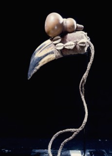 A powerful medicinal object, known as a bocio, accumulating a variety of animal and vegetable parts, including a hornbills beak to which is tied a calabash symbolic of hidden medicine