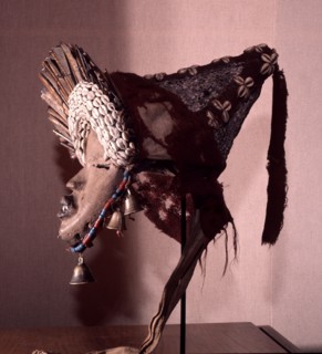 The bells under its chin suggest this mask has risen in status to become one of the powerful glewa or judgement masquerades which arbitrate intra village disputes in association with the go society