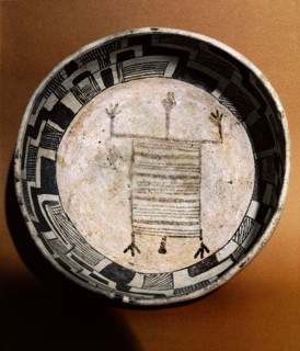Pottery bowl with schematic human figure and black on white geometric design