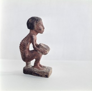 An emaciated man holding a bowl