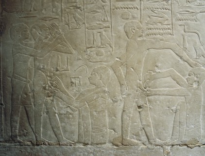 A detail of a relief in the tomb of Ankhmahor at Saqqara depicting a priest performing ritual circumcision on a young boy