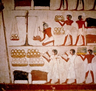 A detail of a wall painting in the tomb of Panekhmen depicting metal workers weighing gold on scales