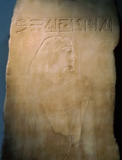 An alabaster panel decorated in sunk relief with a profile head and torso of Rawer