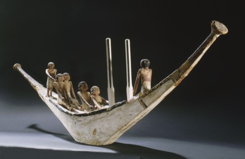 A model of a rowing boat with crew and two steering posts
