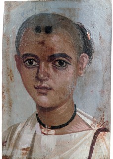 Portrait of a boy wearing gold amulet
