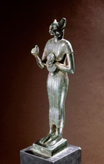 Bronze figure of the cat goddess Bastet, standing with raised right arm, holding a leonine headed aegis