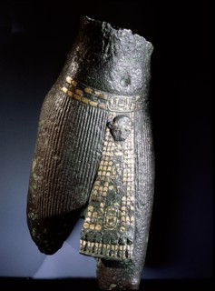Bronze torso with belt and pleated garment decorated with copper and gold
