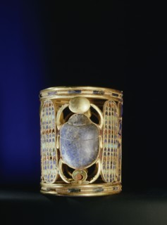 Gold bracelet from the tomb of Amenemope mounted with a lapis lazuli scarab bearing aloft the gold solar disc