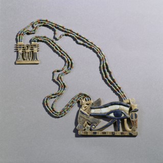 A pendant from the tomb of Tutankhamun in the form of a Wedjat eye, symbol of protection, flanked by the vulture goddess, Nekhbet and the snake goddess Wadjet, protectors of Upper & Lower Egypt