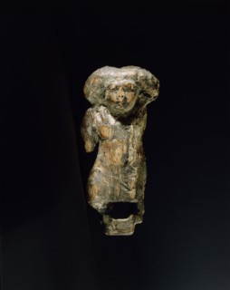 Small ivory statuette in the form of a female dwarf with a massive wig