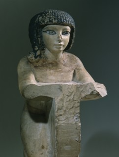 Painted stone figure of a kneeling woman, from an offering scene