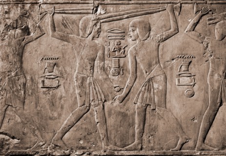 Relief from the tomb of Kharuef of young men in light tunics stick fighting