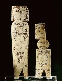 Two Coptic bone dolls of schematic flat peg form with incised circle decoration