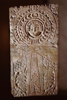 Early Christian stela incorporating a looped cross (crux ansata) or ankh symbol, surrounded by the vine of eternal life, illustrating the fusion of pharaonic iconography with Christian motifs in Byzan...