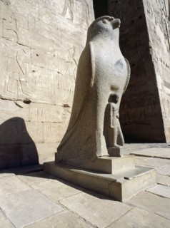 The colossal statue of the god Horus at the entrance to the Temple of Horus, Edfu