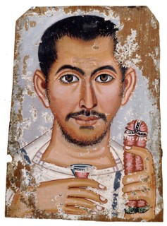 Portrait of a man holding a small glass vessel and garland