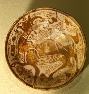 Lustreware plate with a design of a gazelle in lustre on an opaque white glaze