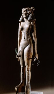 Figurine of a nude female dancer wearing a leonine mask, holding a bronze serpent in each hand