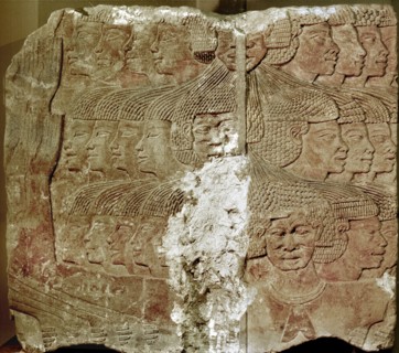 Fragment of a painted relief depicting a group of captive Sea People, tied together by the hair