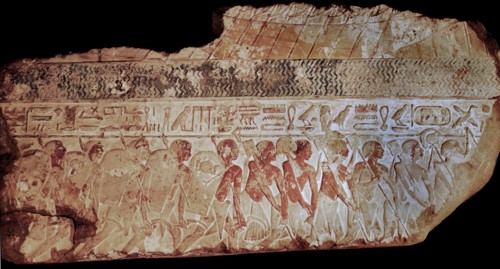 Block from a painted relief showing a parade of soldiers carrying shields,lances and sickles