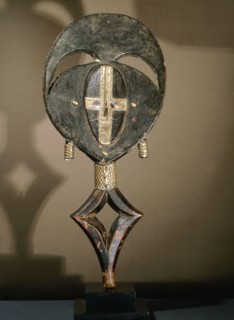 Guardian figures, called mbulu ngulu, are attached to bark boxes or bundles containing bones and other relics of clan or village ancestors, serving to protect them and as a focus for prayers and sacri...