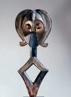 Guardian figures, called mbulu ngulu, are attached to bark boxes or bundles containing bones and other relics of clan or village ancestors, serving to protect them and as a focus for prayers and sacri...