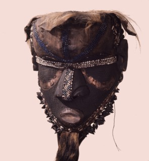 A helmet mask known as Mboom or Bwoom representing local pygmies, the common people, in a play retelling the myth of Bushoong royal origins, performed at major funerals, royal ceremonies and initiatio...