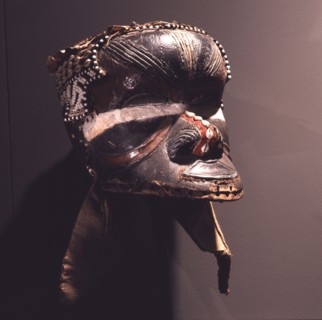 A helmet mask known as Mboom or Bwoom representing local pygmies, the common people, in a play retelling the myth of Bushoong royal origins, performed at major funerals, royal ceremonies and initiatio...