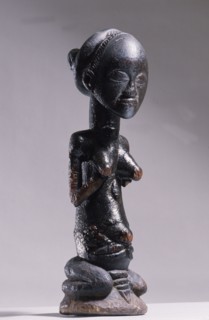 Wooden figure of Luba woman, served as a prestige possesion of a chief or king, illustrating the social and political importance of royal women in Luba society