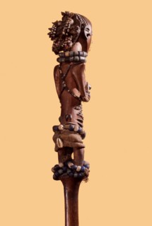 Wooden figure of a young Luba girl decorated with beads and body scarification, forming the finial of a chief or kings staff or sceptre