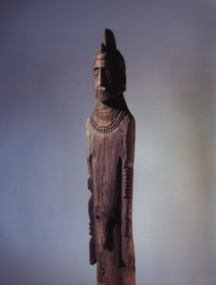Wooden memorial statue used as a grave marker