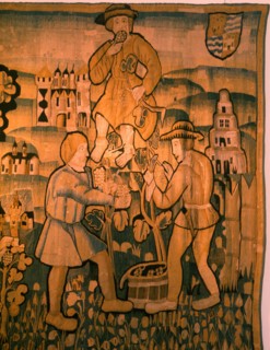 A detail of a tapestry depicting work in the vineyards