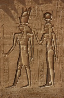 Reliefs on the outer back walls of the temple complex depicting a pharaoh and the goddess Isis
