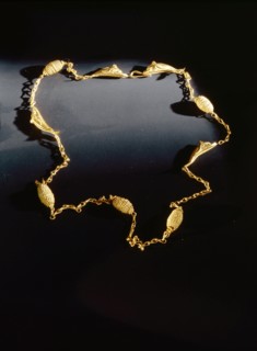Hellenistic gold necklace chain interlinked with four gold dolphins and five twisted wire beads
