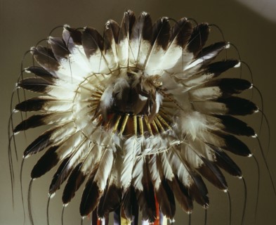 The eagle feather war bonnet, symbol of the outstanding warrior and a source of spiritual power and inspiration, utilized an ingenious method of rawhide strap attachments that made the feathers moveme...