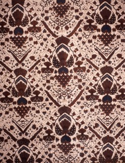 Detail of a batik kain with a design including wings, shrines and sacred mountains