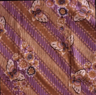 A batik sarong with a design of butterflies and flowers over a simplified version of the scrolled background motif known as parang