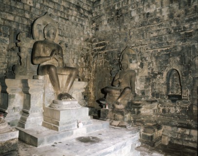 Statues of Buddha and a Bodhisattva in Chandi Mendut, one of the several temples associated with Borobudur