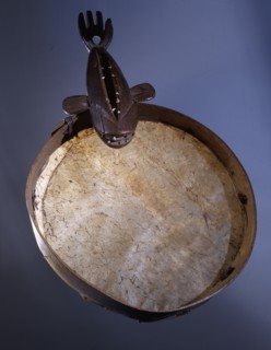 A drum frame with a handle in the shape of a whale