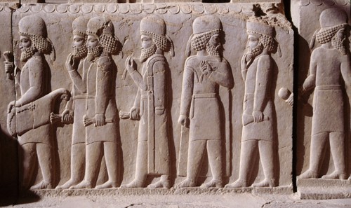 A detail of a relief carving on the staircase leading to the Tripylon at Persepolis, depicting the procession of Medes and Persians