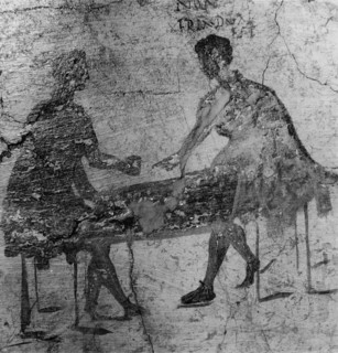 An inn sign depicting two men playing dice