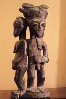 Baule figure sculpture carved for a spirit trance diviner as a focus for sacrifice, It may represent the female diviner protected by the bush spirit that possesses her