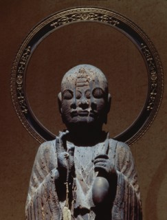 The priest Hoshi, reputed to be the incarnation of a deity, the face of which is emerging from that of the priest in this sculpture