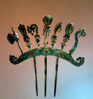 An enamelled silver comb ornamented with sacred ceremonial weapons of ancient China